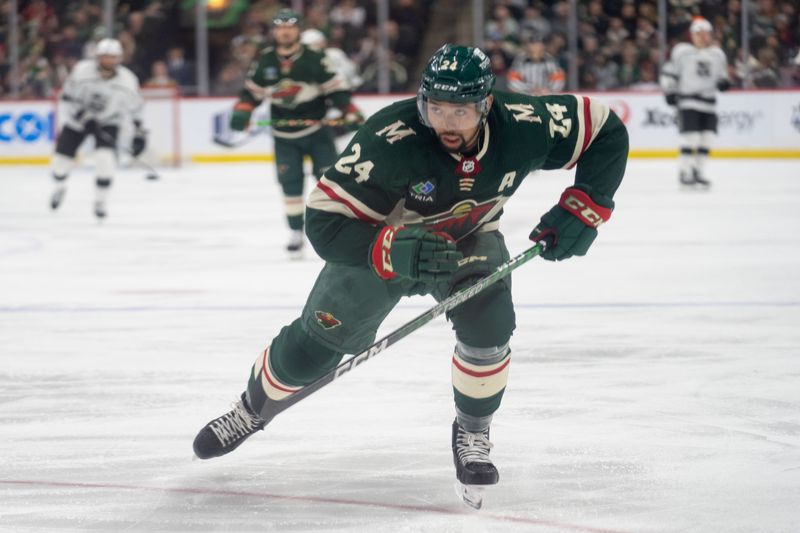 Feb 21, 2023; Saint Paul, Minnesota, USA; Minnesota Wild defenseman Matt Dumba (24) retrieves the puck in after an Los Angeles Kings icing in the third period at Xcel Energy Center. Mandatory Credit: Matt Blewett-USA TODAY Sports