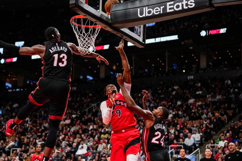 TORONTO, ON - DECEMBER 1: RJ Barrett #9 of the Toronto Raptors shoots the ball as Bam Adebayo #13 and Haywood Highsmith #24 of the Miami Heat defend at Scotiabank Arena on December 1, 2024 in Toronto, Ontario, Canada. NOTE TO USER: User expressly acknowledges and agrees that, by downloading and/or using this Photograph, user is consenting to the terms and conditions of the Getty Images License Agreement. (Photo by Andrew Lahodynskyj/Getty Images)