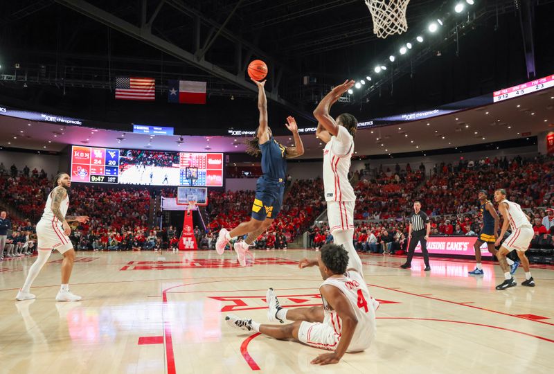 Jan 15, 2025; Houston, Texas, USA; West Virginia Mountaineers guard Javon Small (7) shoots against Houston Cougars forward Ja'Vier Francis (5) in the first half at Fertitta Center. Mandatory Credit: Thomas Shea-Imagn Images