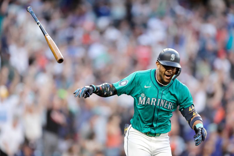 Jul 20, 2024; Seattle, Washington, USA; Seattle Mariners center fielder Julio Rodríguez (44) tosses his bat after hitting a two-run home run against the Houston Astros during the sixth inning at T-Mobile Park. Mandatory Credit: John Froschauer-USA TODAY Sports