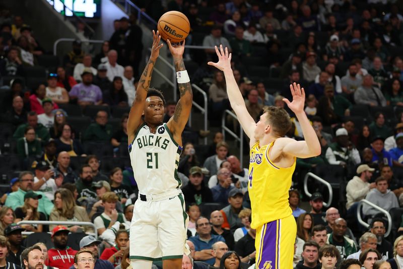 MILWAUKEE, WISCONSIN - OCTOBER 10: Tyler Smith #21 of the Milwaukee Bucks shoots over Dalton Knecht #4 of the Los Angeles Lakers during the second half of a preseason game at Fiserv Forum on October 10, 2024 in Milwaukee, Wisconsin.  NOTE TO USER: User expressly acknowledges and agrees that, by downloading and or using this photograph, User is consenting to the terms and conditions of the Getty Images License Agreement. (Photo by Stacy Revere/Getty Images)