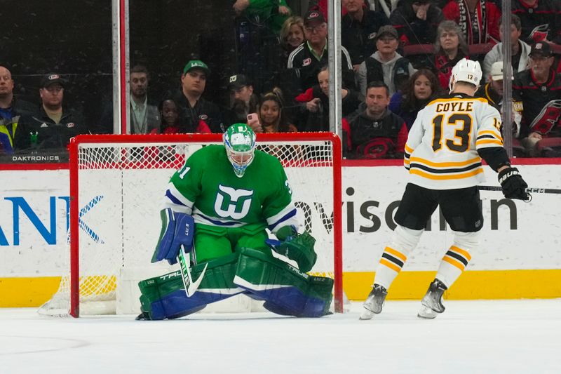 Mar 26, 2023; Raleigh, North Carolina, USA;  Boston Bruins center Charlie Coyle (13) scores a shoot out goal past Carolina Hurricanes goaltender Frederik Andersen (31) at PNC Arena. Mandatory Credit: James Guillory-USA TODAY Sports