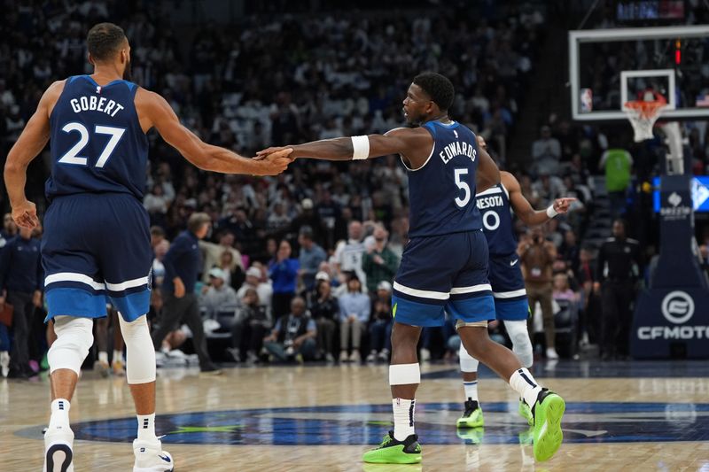 MINNEAPOLIS, MN -  OCTOBER 22: Anthony Edwards #5 and Rudy Gobert #27 of the Minnesota Timberwolves high five during the game against the Toronto Raptors on October 22, 2024 at Target Center in Minneapolis, Minnesota. NOTE TO USER: User expressly acknowledges and agrees that, by downloading and or using this Photograph, user is consenting to the terms and conditions of the Getty Images License Agreement. Mandatory Copyright Notice: Copyright 2024 NBAE (Photo by Jordan Johnson/NBAE via Getty Images)