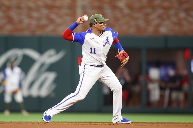 May 20, 2023; Atlanta, Georgia, USA; Atlanta Braves shortstop Orlando Arcia (11) throws a runner out at first against the Seattle Mariners in the seventh inning at Truist Park. Mandatory Credit: Brett Davis-USA TODAY Sports