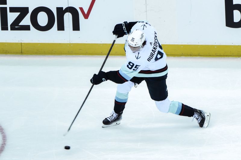 Feb 12, 2024; Newark, New Jersey, USA; Seattle Kraken left wing Andre Burakovsky (95) takes a shot during the third period against the New Jersey Devils at Prudential Center. Mandatory Credit: John Jones-USA TODAY Sports