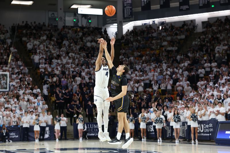 Jan 30, 2024; Logan, Utah, USA; Utah State Aggies guard Ian Martinez (4) shoots over San Jose State Spartans guard Alvaro Cardenas (13) during the second half at Dee Glen Smith Spectrum. Mandatory Credit: Rob Gray-USA TODAY Sports