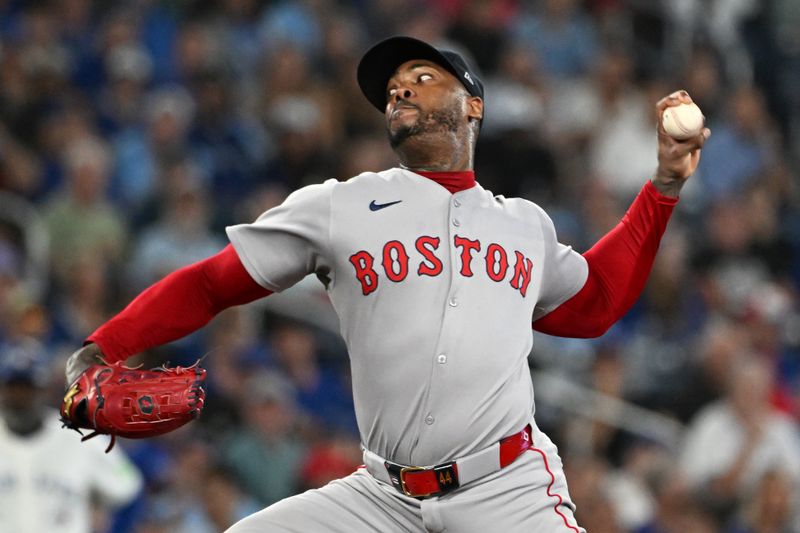Sep 23, 2025; Toronto, Ontario, CAN;  Boston Red Sox relief pitcher Aroldis Chapman (44) delivers a pitch against the Toronto Blue Jays in the ninth inning at Rogers Centre. Mandatory Credit: Dan Hamilton-Imagn Images