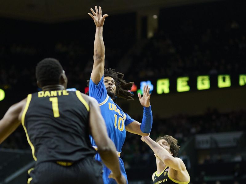 Feb 11, 2023; Eugene, Oregon, USA; UCLA Bruins guard Tyger Campbell (10) shoots a basket during the second half against Oregon Ducks center N'Faly Dante (1) at Matthew Knight Arena. Mandatory Credit: Troy Wayrynen-USA TODAY Sports