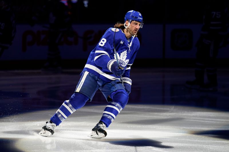 Nov 8, 2024; Toronto, Ontario, CAN; Toronto Maple Leafs defenceman Chris Tanev (8) skates during the player introductions before a game against the Detroit Red Wings  at Scotiabank Arena. Mandatory Credit: John E. Sokolowski-Imagn Images