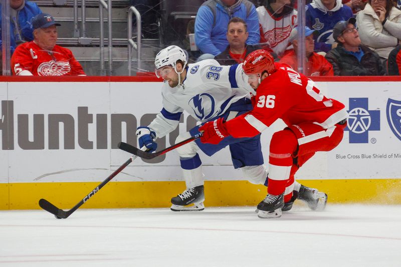 Jan 21, 2024; Detroit, Michigan, USA; Tampa Bay Lightning left wing Brandon Hagel (38) handles the puck against Detroit Red Wings defenseman Jake Walman (96) during the third period at Little Caesars Arena. Mandatory Credit: Brian Bradshaw Sevald-USA TODAY Sports