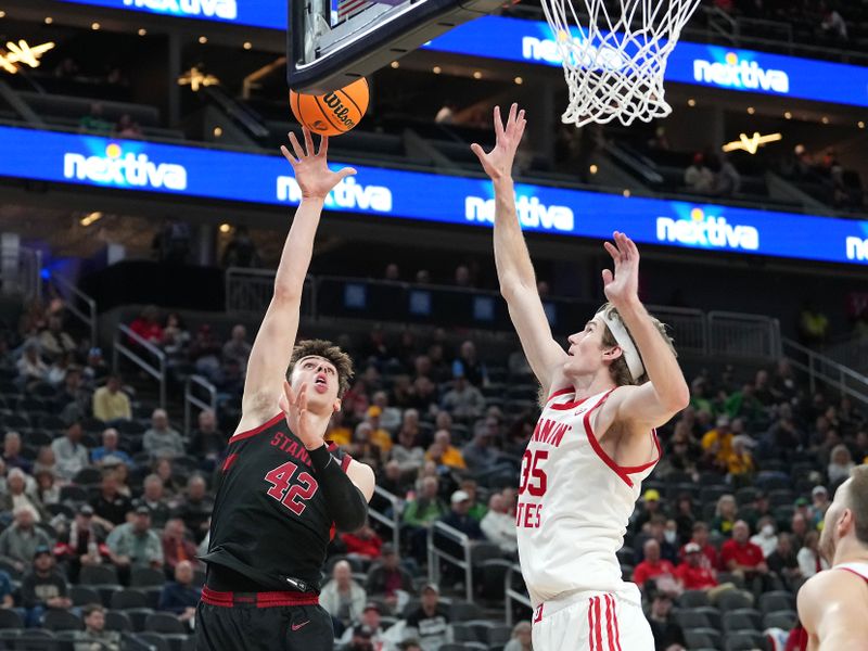 Mar 8, 2023; Las Vegas, NV, USA; Stanford Cardinal forward Maxime Raynaud (42) shoots against Utah Utes center Branden Carlson (35) during the first half at T-Mobile Arena. Mandatory Credit: Stephen R. Sylvanie-USA TODAY Sports