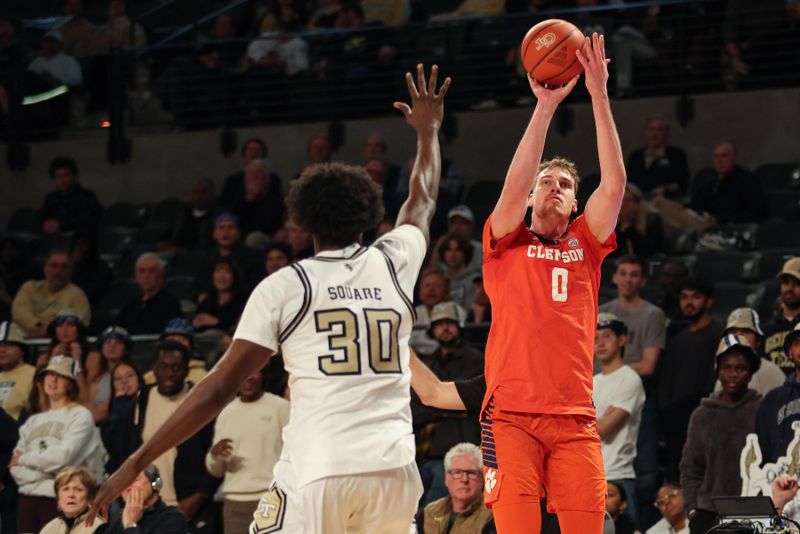 Jan 14, 2025; Atlanta, Georgia, USA; Clemson Tigers center Viktor Lakhin (0) shoots the ball over Georgia Tech Yellow Jackets forward Ibrahim Souare (30) during the second half at McCamish Pavilion. Mandatory Credit: Jordan Godfree-Imagn Images