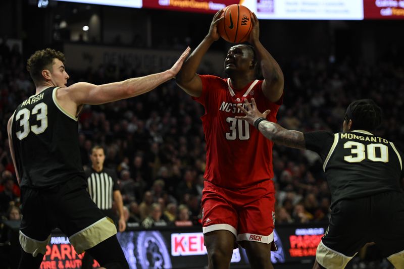 Jan 28, 2023; Winston-Salem, North Carolina, USA;   North Carolina State Wolfpack forward D.J. Burns Jr. (30) shoots over Wake Forest Demon Deacons forward Matthew Marsh (33) during the second half at Lawrence Joel Veterans Memorial Coliseum. Mandatory Credit: William Howard-USA TODAY Sports