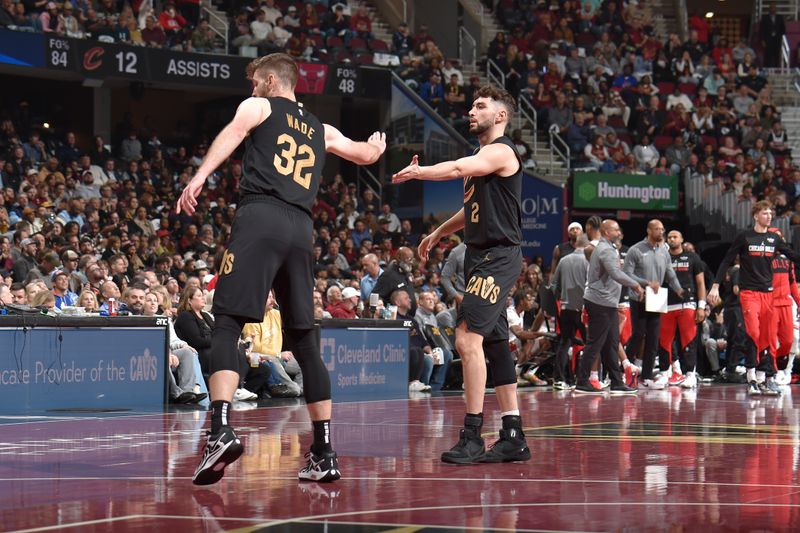 CLEVELAND, OH - November 15: Dean Wade #32 and Ty Jerome #2 of the Cleveland Cavaliers high five during the game against the Chicago Bulls during the Emirates NBA Cup game on November 15, 2024 at Rocket Mortgage FieldHouse in Cleveland, Ohio. NOTE TO USER: User expressly acknowledges and agrees that, by downloading and/or using this Photograph, user is consenting to the terms and conditions of the Getty Images License Agreement. Mandatory Copyright Notice: Copyright 2024 NBAE (Photo by David Liam Kyle/NBAE via Getty Images)