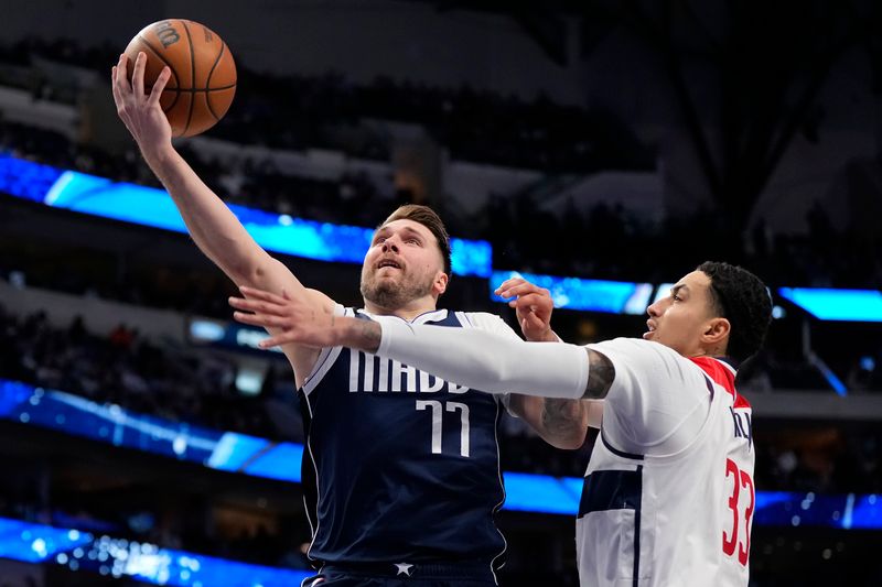 DALLAS, TEXAS - FEBRUARY 12: Luka Doncic #77 of the Dallas Mavericks goes up for a shot against Kyle Kuzma #33 of the Washington Wizards during the second half at American Airlines Center on February 12, 2024 in Dallas, Texas. NOTE TO USER: User expressly acknowledges and agrees that, by downloading and or using this photograph, User is consenting to the terms and conditions of the Getty Images License Agreement. (Photo by Sam Hodde/Getty Images)