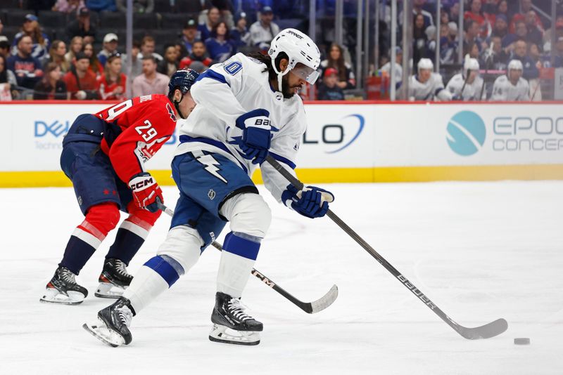 Apr 13, 2024; Washington, District of Columbia, USA; Tampa Bay Lightning left wing Anthony Duclair (10) skates with the puck as Washington Capitals center Hendrix Lapierre (29) chases in the first period at Capital One Arena. Mandatory Credit: Geoff Burke-USA TODAY Sports