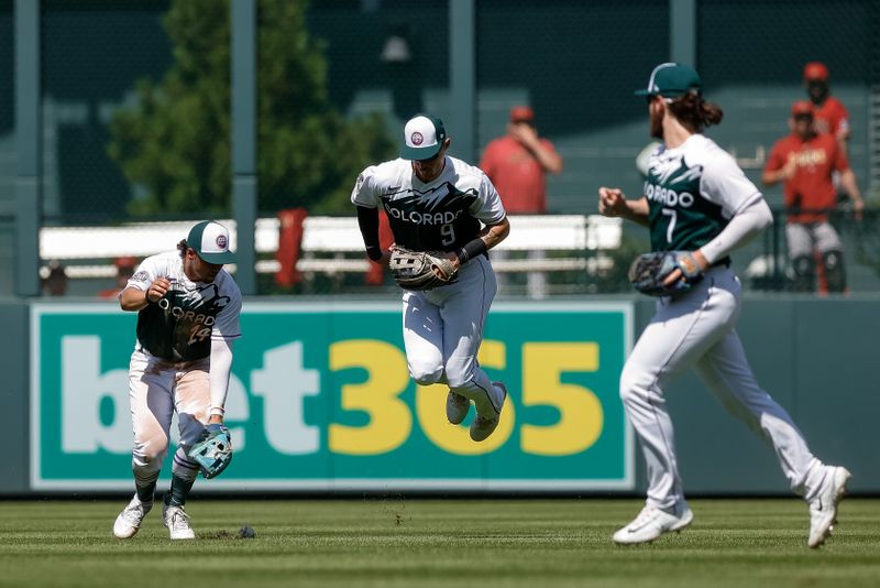 Aug 16, 2023; Denver, Colorado, USA; Colorado Rockies shortstop Ezequiel Tovar (14) and center fielder Brenton Doyle (9) are unable to make a catch as the ball his the grass as second baseman Brendan Rodgers (7) looks on in the sixth inning against the Arizona Diamondbacks at Coors Field. Mandatory Credit: Isaiah J. Downing-USA TODAY Sports