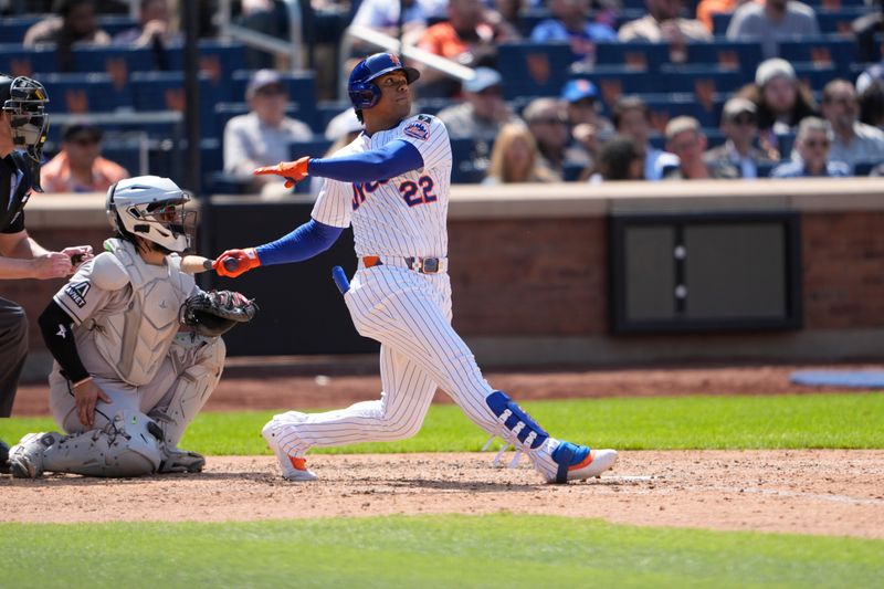 May 1, 2025; New York City, New York, USA; New York Mets right fielder Juan Soto (22) hits a home run against the Arizona Diamondbacks during the sixth inning at Citi Field. Mandatory Credit: Gregory Fisher-Imagn Images