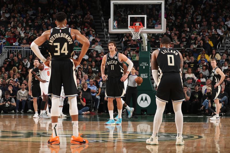 MILWAUKEE, WI - APRIL 7: Brook Lopez #11, Giannis Antetokounmpo #34 and Damian Lillard #0 of the Milwaukee Bucks look on during the game against the New York Knicks on April 7, 2024 at the Fiserv Forum Center in Milwaukee, Wisconsin. NOTE TO USER: User expressly acknowledges and agrees that, by downloading and or using this Photograph, user is consenting to the terms and conditions of the Getty Images License Agreement. Mandatory Copyright Notice: Copyright 2024 NBAE (Photo by Gary Dineen/NBAE via Getty Images).