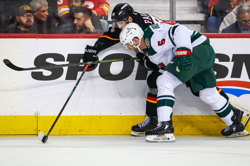 Dec 4, 2025; Calgary, Alberta, CAN; Calgary Flames left wing Joel Farabee (86) and Minnesota Wild defenseman Jake Middleton (5) battle for the puck during the second period at Scotiabank Saddledome. Mandatory Credit: Sergei Belski-Imagn Images