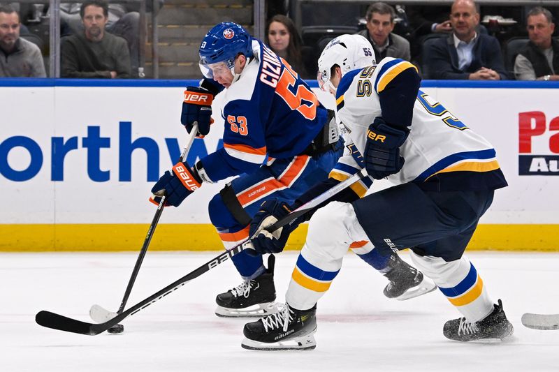 Mar 5, 2024; Elmont, New York, USA;  New York Islanders center Casey Cizikas (53) skates against St. Louis Blues defenseman Colton Parayko (55) during the second period at UBS Arena. Mandatory Credit: Dennis Schneidler-USA TODAY Sports