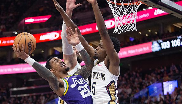 SALT LAKE CITY, UT - NOVEMBER 27: John Collins #20 of the Utah Jazz drives to the basket under pressure from Herbert Jones #5 (R) and Jonas Valanciunas #17 of the New Orleans Pelicans during the second half of their game at the Delta Center on November 27, 2023 in Salt Lake City, Utah.  NOTE TO USER: User expressly acknowledges and agrees that, by downloading and or using this photograph, User is consenting to the terms and conditions of the Getty Images License Agreement.  (Photo by Chris Gardner/Getty Images)