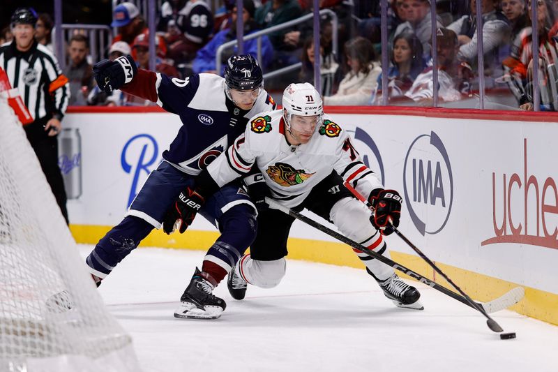 Oct 28, 2024; Denver, Colorado, USA; Colorado Avalanche defenseman Sam Malinski (70) and Chicago Blackhawks left wing Taylor Hall (71) battle for the puck in the third period at Ball Arena. Mandatory Credit: Isaiah J. Downing-Imagn Images