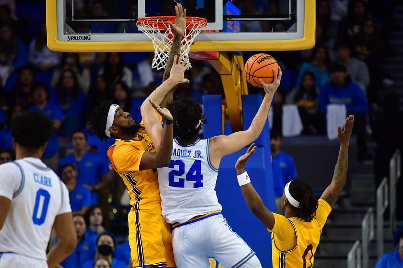 Mar 2, 2023; Los Angeles, California, USA; UCLA Bruins guard Jaime Jaquez Jr. (24) moves to the basket against Arizona State Sun Devils forward Warren Washington (22) and guard DJ Horne (0) during the first half at Pauley Pavilion. Mandatory Credit: Gary A. Vasquez-USA TODAY Sports