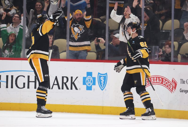 Mar 11, 2025; Pittsburgh, Pennsylvania, USA;  Pittsburgh Penguins right wing Rickard Rakell (left) and defenseman Erik Karlsson (65) celebrate the game winning goal by Karlsson to defeat the Vegas Golden Knights in overtime at PPG Paints Arena. Mandatory Credit: Charles LeClaire-Imagn Images