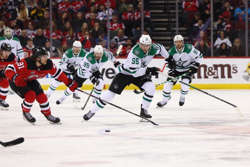 Jan 20, 2024; Newark, New Jersey, USA; New Jersey Devils center Dawson Mercer (91) and Dallas Stars defenseman Thomas Harley (55) race for the puck during the third period at Prudential Center. Mandatory Credit: Ed Mulholland-USA TODAY Sports