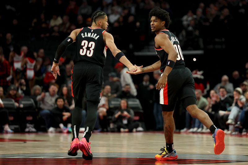 PORTLAND, OREGON - JANUARY 14: Toumani Camara #33 and Scoot Henderson #00 of the Portland Trail Blazers react during the first half against the Brooklyn Nets at Moda Center on January 14, 2025 in Portland, Oregon. NOTE TO USER: User expressly acknowledges and agrees that, by downloading and or using this photograph, User is consenting to the terms and conditions of the Getty Images License Agreement. (Photo by Steph Chambers/Getty Images)