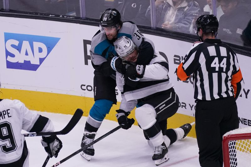 Nov 20, 2025; San Jose, California, USA;  San Jose Sharks defenseman Mario Ferraro (38) and Los Angeles Kings center Alex Turcotte (15) fight during the third period at SAP Center at San Jose. Mandatory Credit: David Gonzales-Imagn Images