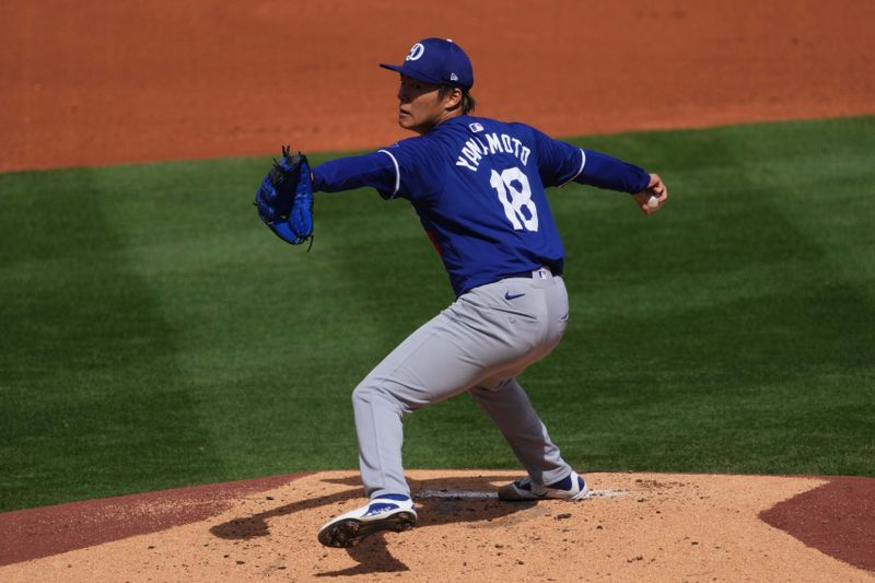 Feb 28, 2024; Surprise, Arizona, USA; Los Angeles Dodgers starting pitcher Yoshinobu Yamamoto (18) pitches during the third inning against the Texas Rangers at Surprise Stadium. Mandatory Credit: Joe Camporeale-USA TODAY Sports