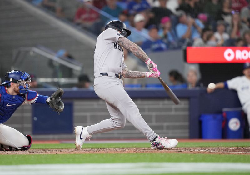 Jun 30, 2024; Toronto, Ontario, CAN; New York Yankees outfielder Alex Verdugo (24) hits a double against the Toronto Blue Jays during the sixth inning at Rogers Centre. Mandatory Credit: Nick Turchiaro-USA TODAY Sports