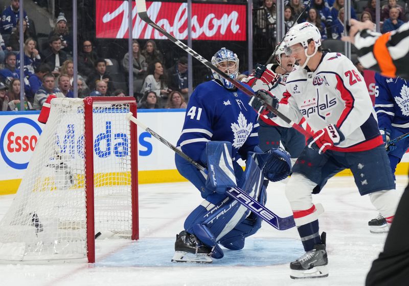 Dec 6, 2024; Toronto, Ontario, CAN; Washington Capitals center Nic Dowd (26) scores a goal on Toronto Maple Leafs goaltender Anthony Stolarz (41) during the second period at Scotiabank Arena. Mandatory Credit: Nick Turchiaro-Imagn Images