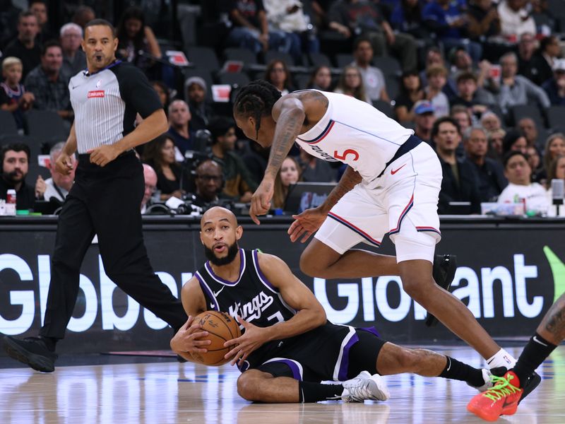 INGLEWOOD, CALIFORNIA - OCTOBER 17: Jordan McLaughlin #3 of the Sacramento Kings falls with the ball in front of Bones Hyland #5 of the LA Clippers during the first half in a pre-season game at Intuit Dome on October 17, 2024 in Inglewood, California. (Photo by Harry How/Getty Images)