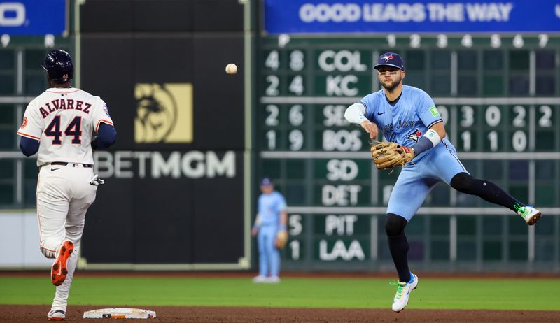 Apr 23, 2025; Houston, Texas, USA; Toronto Blue Jays shortstop Bo Bichette (11) forces Houston Astros designated hitter Yordan Alvarez (44) out at second base but is not enough to turn the double play in time in the fifth inning at Daikin Park. Mandatory Credit: Thomas Shea-Imagn Images