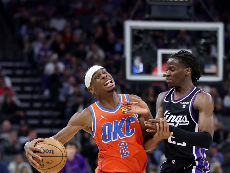 SACRAMENTO, CALIFORNIA - DECEMBER 14: Shai Gilgeous-Alexander #2 of the Oklahoma City Thunder is fouled by Keon Ellis #23 of the Sacramento Kings in the first half at Golden 1 Center on December 14, 2023 in Sacramento, California. NOTE TO USER: User expressly acknowledges and agrees that, by downloading and or using this photograph, User is consenting to the terms and conditions of the Getty Images License Agreement.  (Photo by Ezra Shaw/Getty Images)