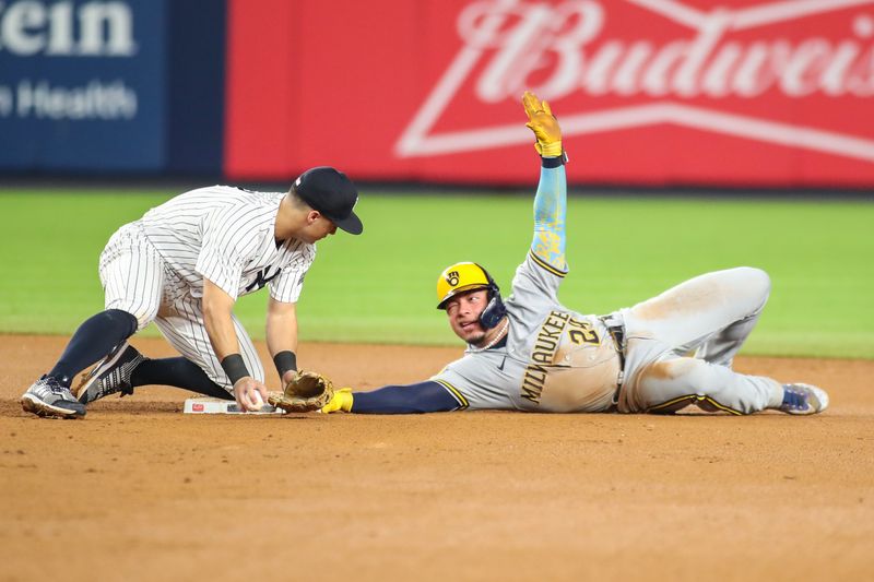 Sep 8, 2023; Bronx, New York, USA;   New York Yankees shortstop Anthony Volpe (11) drops the ball allowing Milwaukee Brewers catcher William Contreras (24) to steal second in the seventh inning at Yankee Stadium. Mandatory Credit: Wendell Cruz-USA TODAY Sports