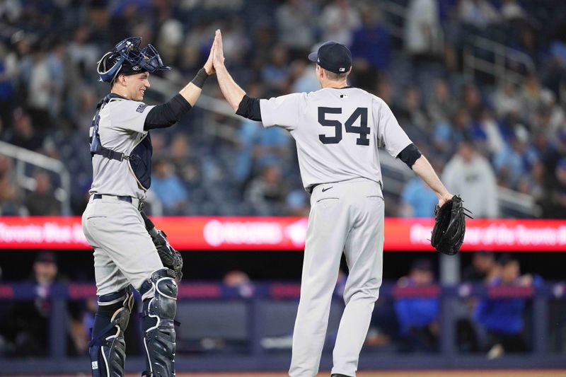 Jun 28, 2024; Toronto, Ontario, CAN; New York Yankees catcher Ben Rice (93) celebrates the win with New York Yankees relief pitcher Tim Hill (54) against the Toronto Blue Jays at Rogers Centre. Mandatory Credit: Nick Turchiaro-USA TODAY Sports