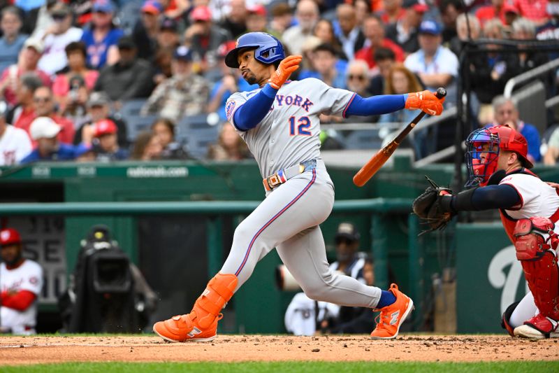 Aug 21, 2025; Washington, District of Columbia, USA; New York Mets shortstop Francisco Lindor (12) singles against the Washington Nationals during the third inning at Nationals Park. Mandatory Credit: Brad Mills-Imagn Images