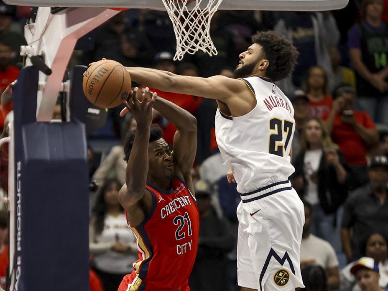 NEW ORLEANS, LOUISIANA - NOVEMBER 15:  Jamal Murray #27 of the Denver Nuggets knocks the ball away from Yves Missi #21 of the New Orleans Pelicans during the first half of an Emirates NBA Cup game at the Smoothie King Center on November 15, 2024 in New Orleans, Louisiana. NOTE TO USER: User expressly acknowledges and agrees that, by downloading and or using this photograph, User is consenting to the terms and conditions of the Getty Images License Agreement. (Photo by Derick E. Hingle/Getty Images)