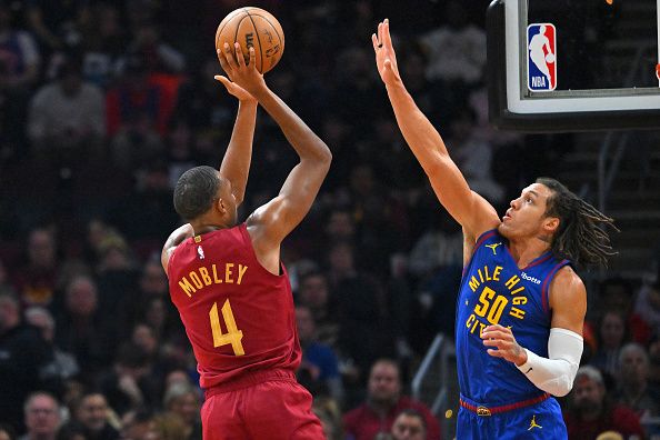 CLEVELAND, OHIO - NOVEMBER 19: Evan Mobley #4 of the Cleveland Cavaliers shoots over Aaron Gordon #50 of the Denver Nuggets during the second quarter at Rocket Mortgage Fieldhouse on November 19, 2023 in Cleveland, Ohio. NOTE TO USER: User expressly acknowledges and agrees that, by downloading and or using this photograph, User is consenting to the terms and conditions of the Getty Images License Agreement. (Photo by Jason Miller/Getty Images)