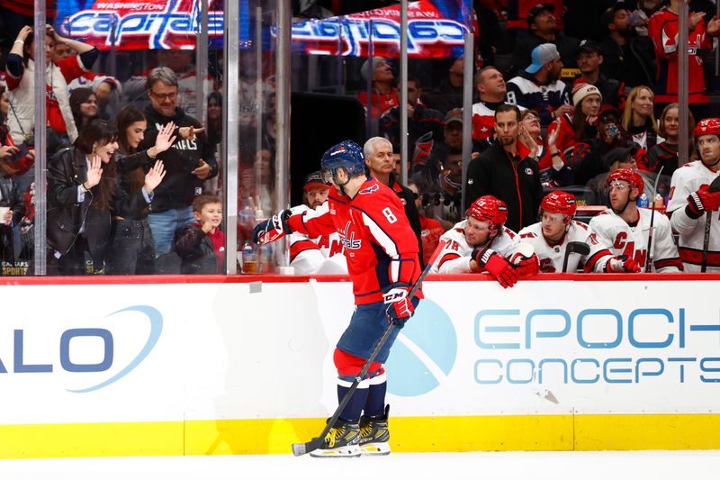 Mar 22, 2024; Washington, District of Columbia, USA; Washington Capitals left wing Alex Ovechkin (8) celebrates with his son Sergei Ovechkin in the stands after scoring a goal during the second period against the Carolina Hurricanes at Capital One Arena. Mandatory Credit: Amber Searls-USA TODAY Sports