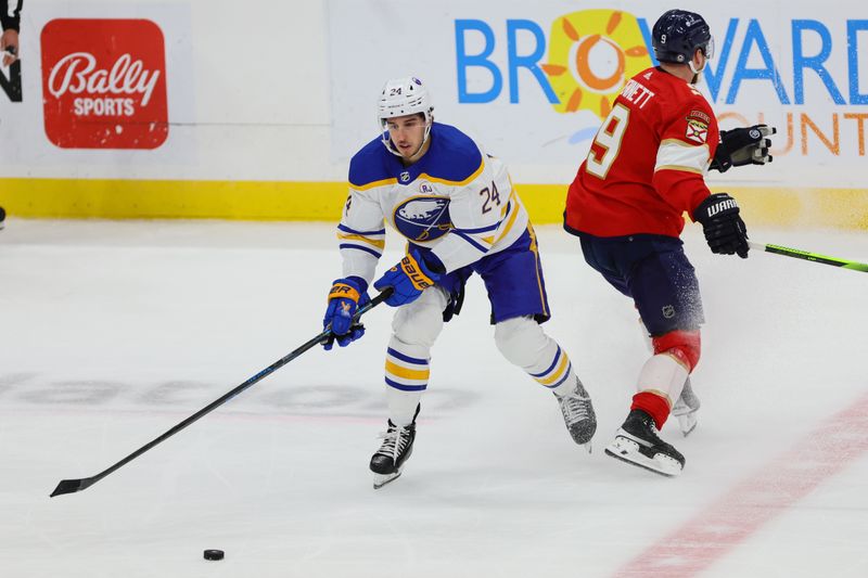 Apr 13, 2024; Sunrise, Florida, USA; Buffalo Sabres center Dylan Cozens (24) moves the puck past Florida Panthers center Sam Bennett (9) during the third period at Amerant Bank Arena. Mandatory Credit: Sam Navarro-USA TODAY Sports