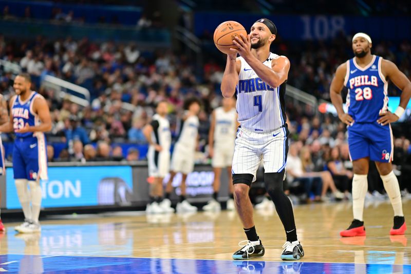 ORLANDO, FLORIDA - OCTOBER 18: Jalen Suggs #4 of the Orlando Magic shoots a technical free throw in the second half of a game against the Philadelphia 76ers at Kia Center on October 18, 2024 in Orlando, Florida. NOTE TO USER: User expressly acknowledges and agrees that, by downloading and or using this photograph, User is consenting to the terms and conditions of the Getty Images License Agreement. (Photo by Julio Aguilar/Getty Images)