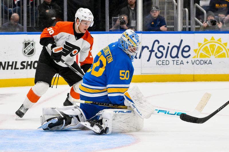 Nov 14, 2025; St. Louis, Missouri, USA; St. Louis Blues goaltender Jordan Binnington (50) defends the net against Philadelphia Flyers right wing Matvei Michkov (39) during the first period at Enterprise Center. Mandatory Credit: Jeff Curry-Imagn Images