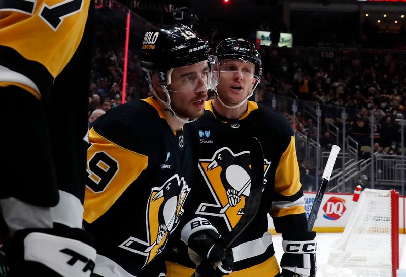 Mar 5, 2024; Pittsburgh, Pennsylvania, USA; Pittsburgh Penguins right wing Reilly Smith (19) celebrates his goal with defenseman Chad Ruhwedel (right) against the Columbus Blue Jackets during the third period at PPG Paints Arena. The Penguins won 5-3. Mandatory Credit: Charles LeClaire-USA TODAY Sports