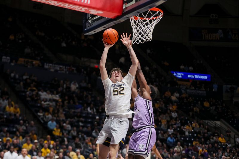 Jan 27, 2026; Morgantown, West Virginia, USA; West Virginia Mountaineers guard Treysen Eaglestaff (52) shoots in the lane against Kansas State Wildcats forward Taj Manning (15) during the second half at Hope Coliseum. Mandatory Credit: Ben Queen-Imagn Imagesa