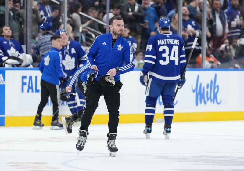 Feb 15, 2024; Toronto, Ontario, CAN; The ice crew gather the hats off the ice after Toronto Maple Leafs center Auston Matthews (34) scored his third goal against the Philadelphia Flyers during the second period at Scotiabank Arena. Mandatory Credit: Nick Turchiaro-USA TODAY Sports